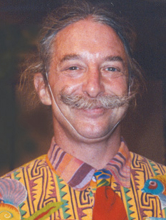 photo of Patch with a huge smile and wearing a brightly colored shirt